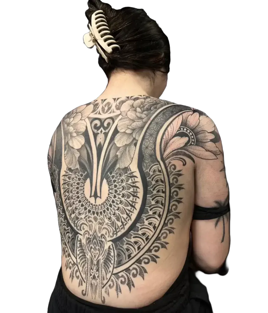 Women’s back piece tattoo with a floral mandala and lace ornamental design in fine line and dotwork by Duk Tattoo, Florida