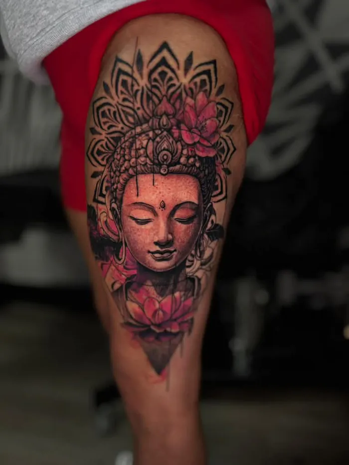 Buddha tattoo with a mandala crown and pink lotus flowers, black and grey with color accents by Duk Tattoo, Boca Raton