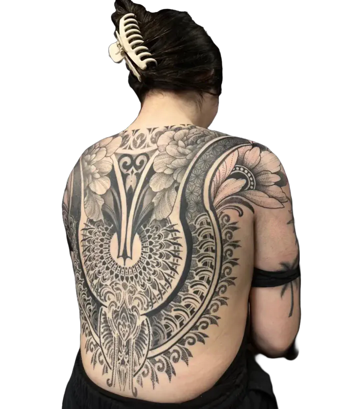 Women’s back piece tattoo with a floral mandala and lace ornamental design in fine line and dotwork by Duk Tattoo, Florida