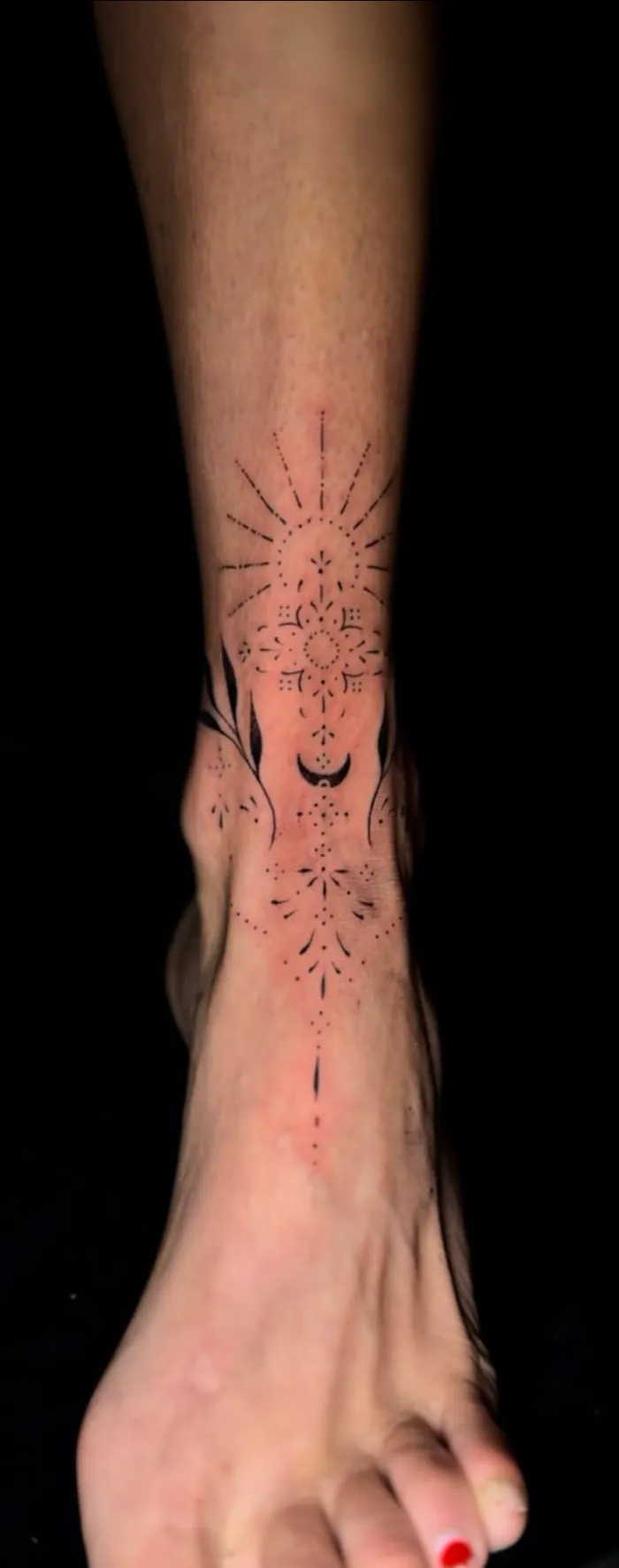 Fine line ornamental tattoo with dots and a crescent moon from the ankle to the foot by Duk Tattoo, Boca Raton, Florida