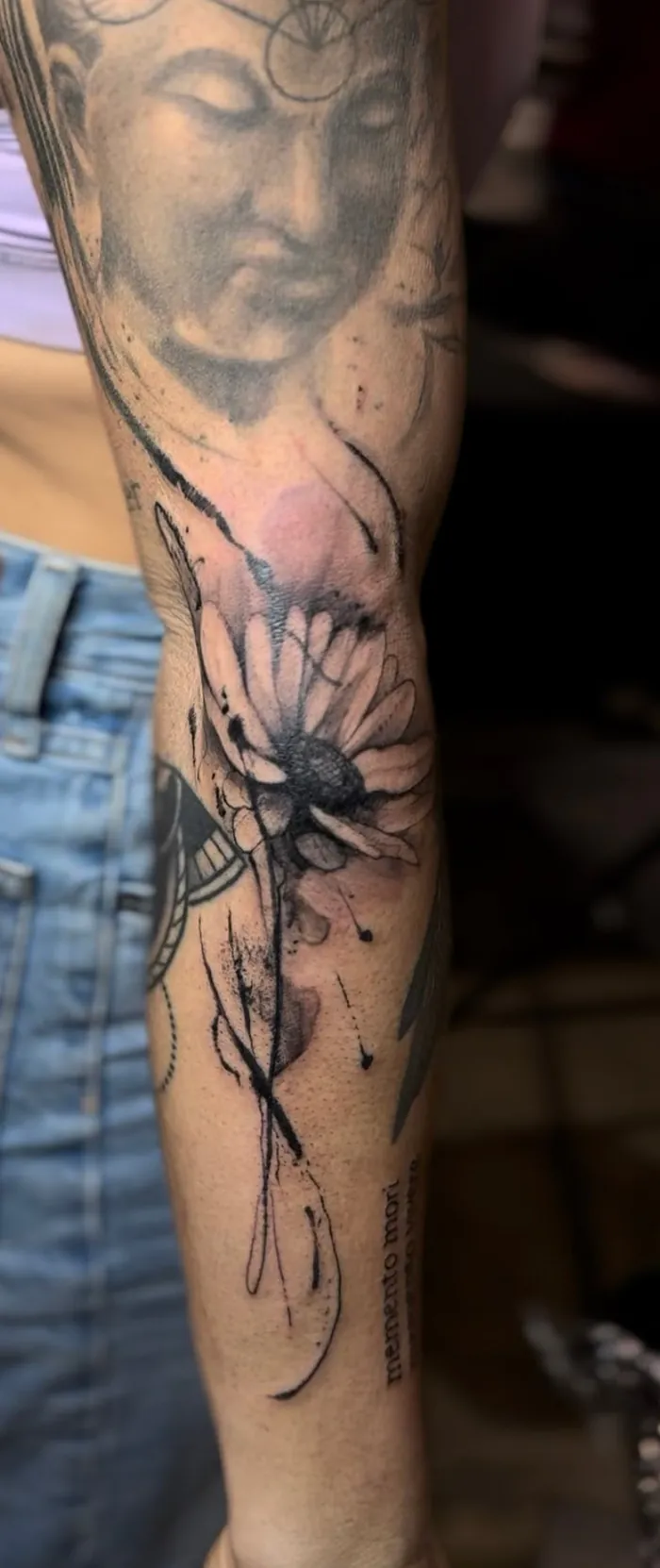 Fine line forearm tattoo of a flower in a loose sketch style in black and grey by Duk Tattoo, Boca Raton, Florida