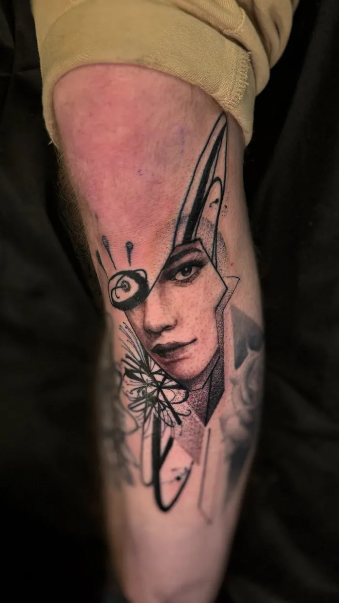 Surreal fine line forearm tattoo of a woman portrait with an eye and a blade in black and grey by Duk Tattoo, Boca Raton, Florida