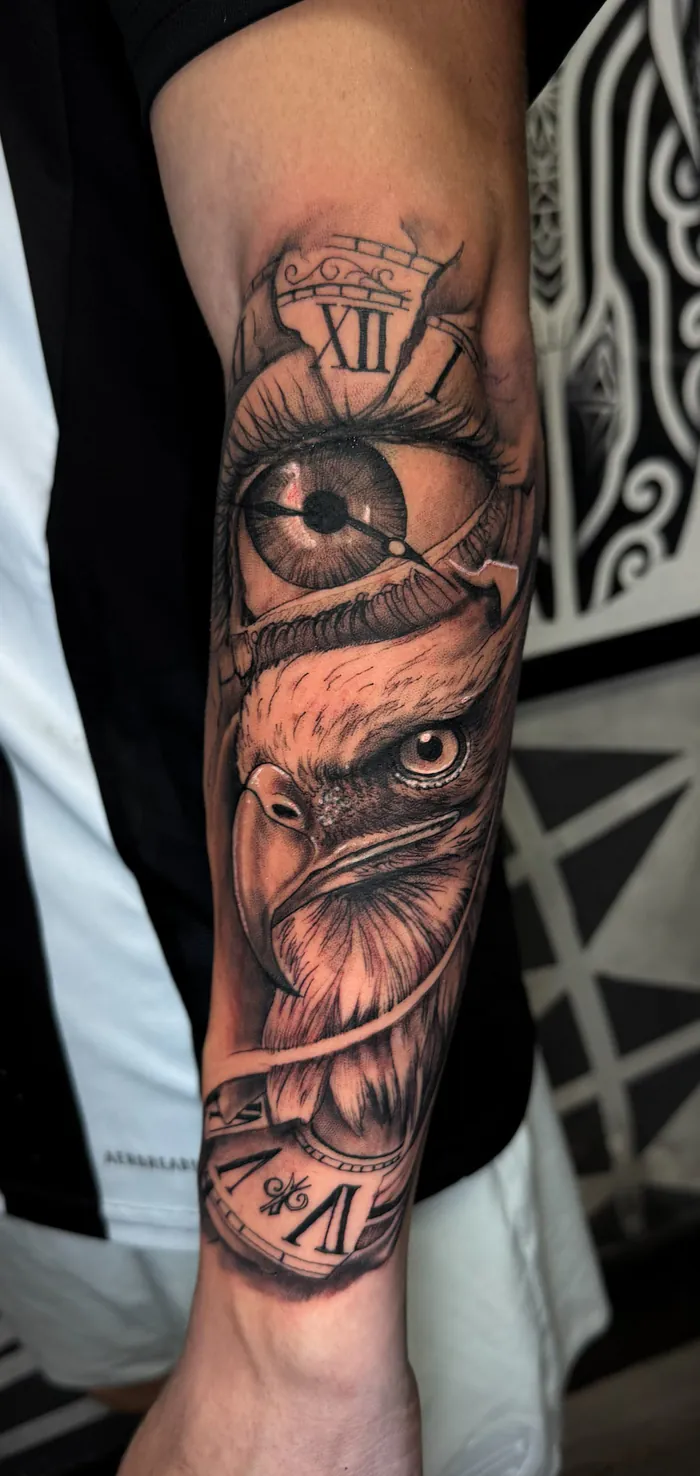 Black and grey realism forearm tattoo of an eye, a clock and an eagle by Duk Tattoo, Boca Raton, Florida