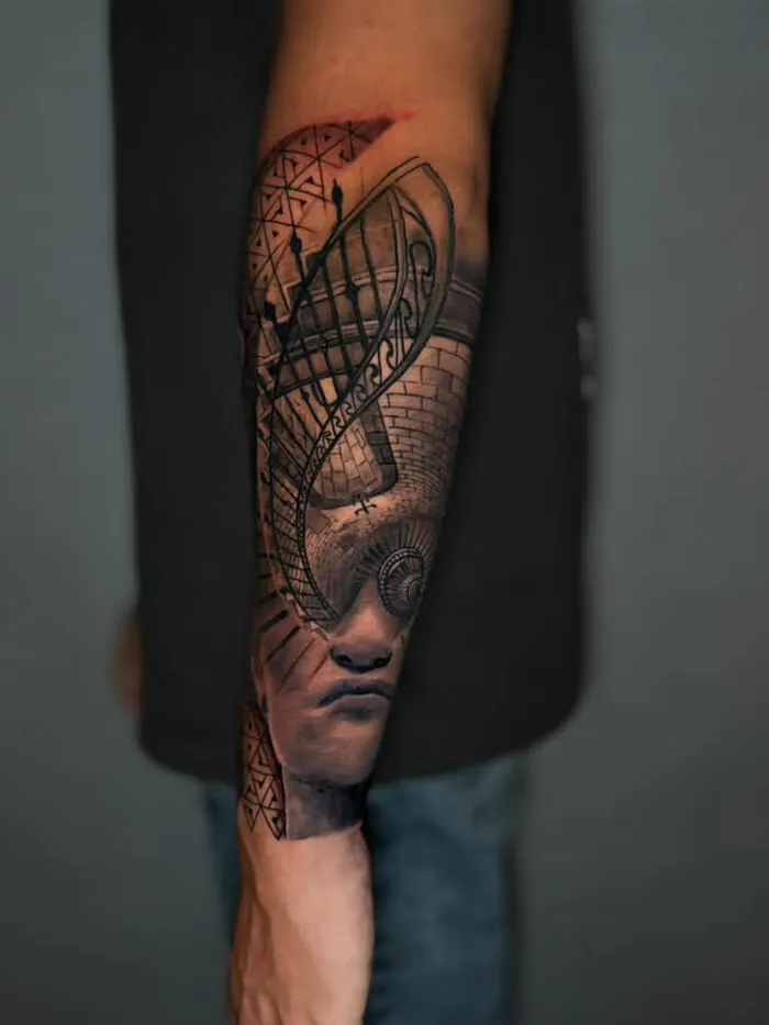 Black and grey surreal forearm tattoo of a portrait with architectural lines by Duk Tattoo, Boca Raton, Florida