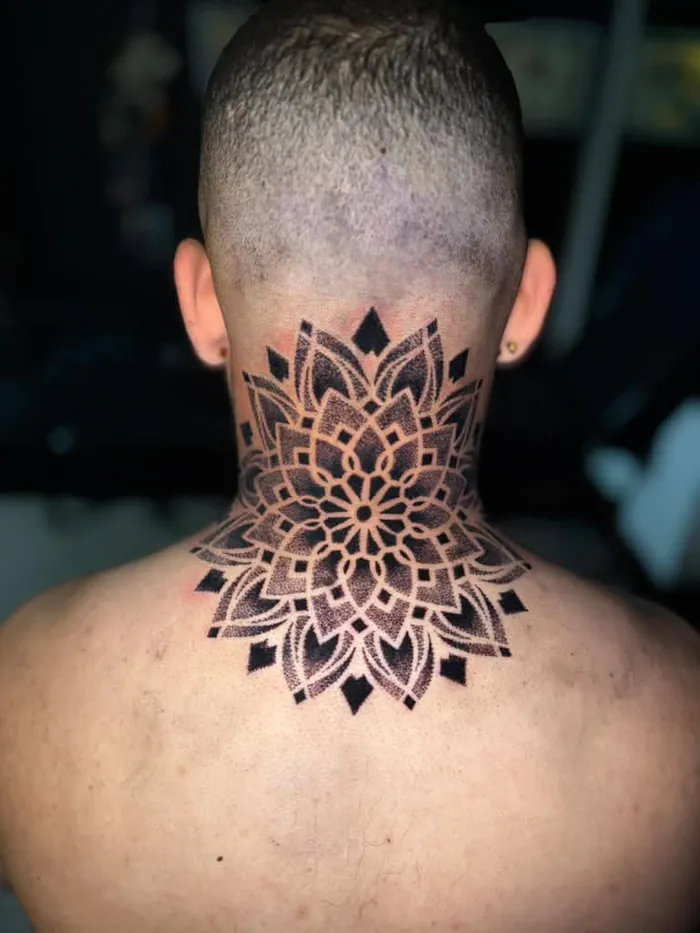 Back of the neck mandala tattoo in blackwork dotwork with ornamental petals by Duk Tattoo, Boca Raton, Florida