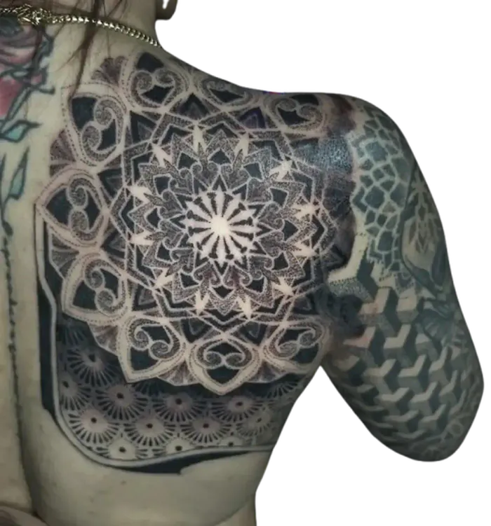 Shoulder and chest piece mandala shield tattoo with geometric honeycomb dotwork by Duk Tattoo, Florida